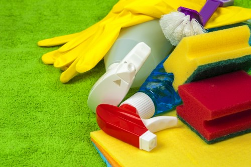 Local cleaner vacuuming and dusting in a Westkensington flat