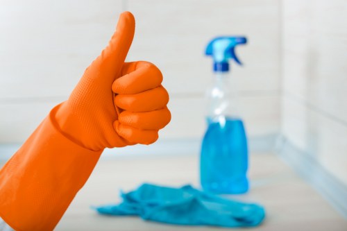 Professional cleaner maintaining an office kitchen and shared surfaces