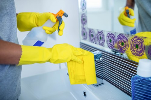 Professional cleaners following safe procedures in a West Kensington property